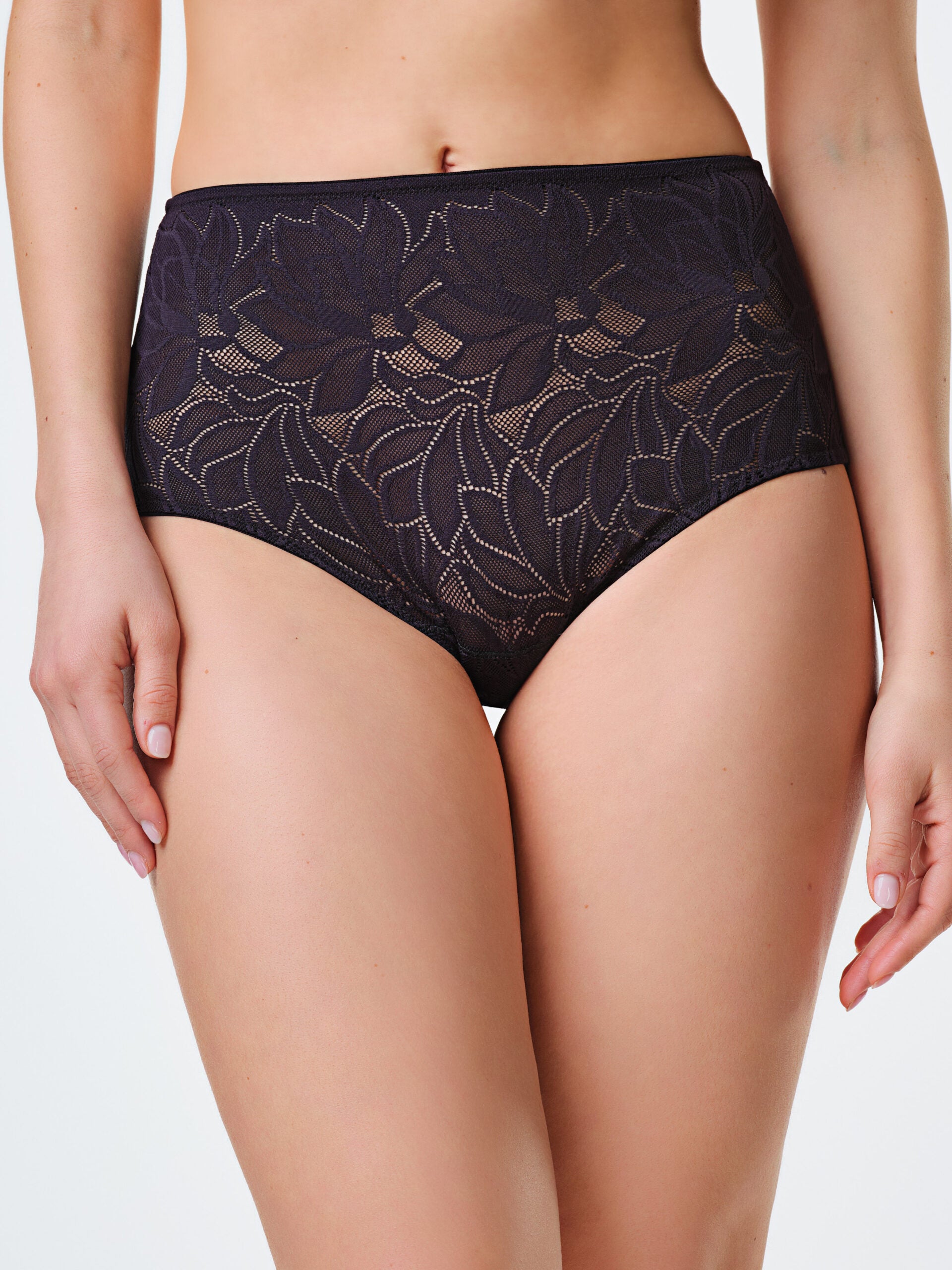 Guaina nera in tessuto elastico jacquard floreale, taglio vivo sul retro.