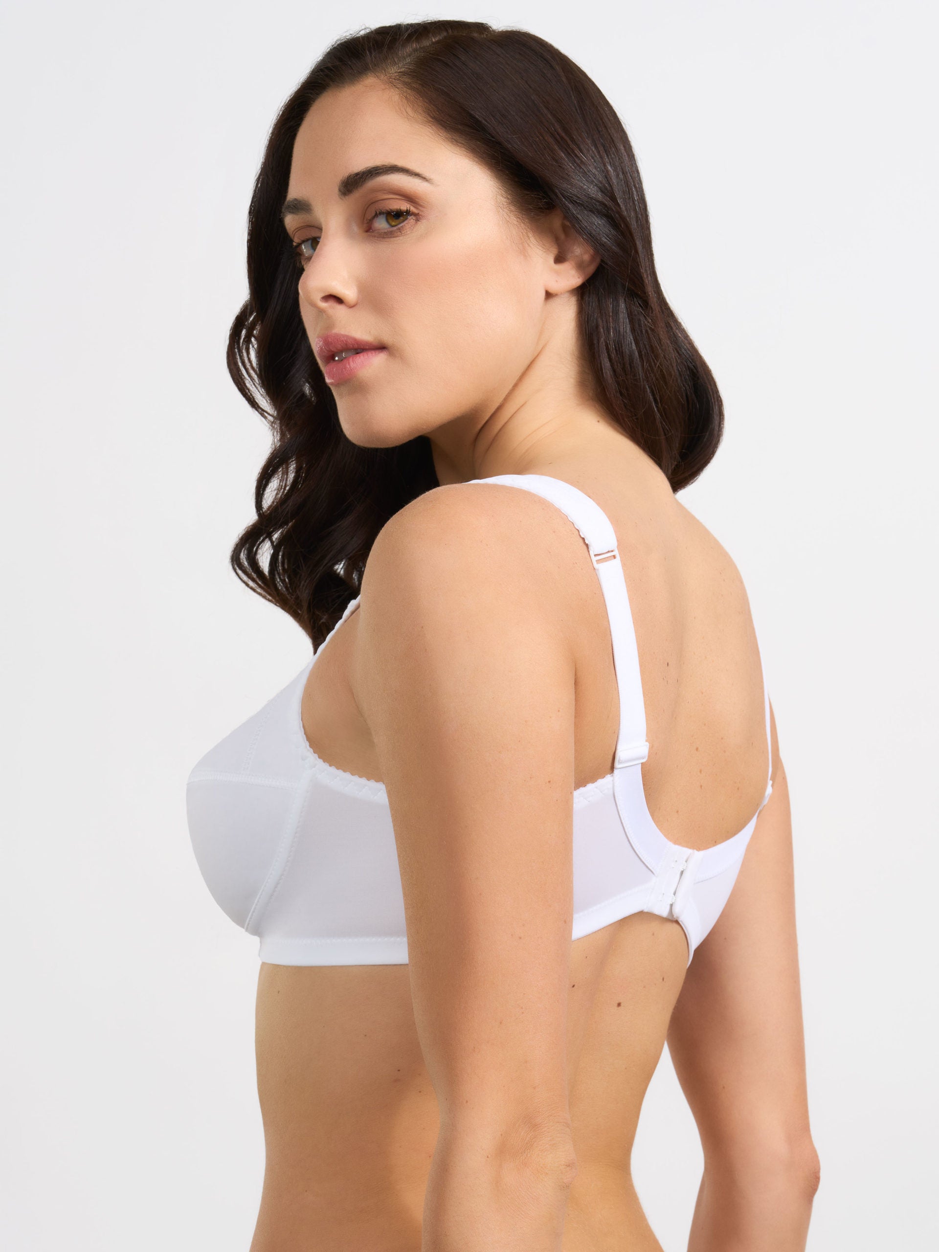 Reggiseno bianco elasticizzato con spalline anatomiche imbottite, vista laterale.