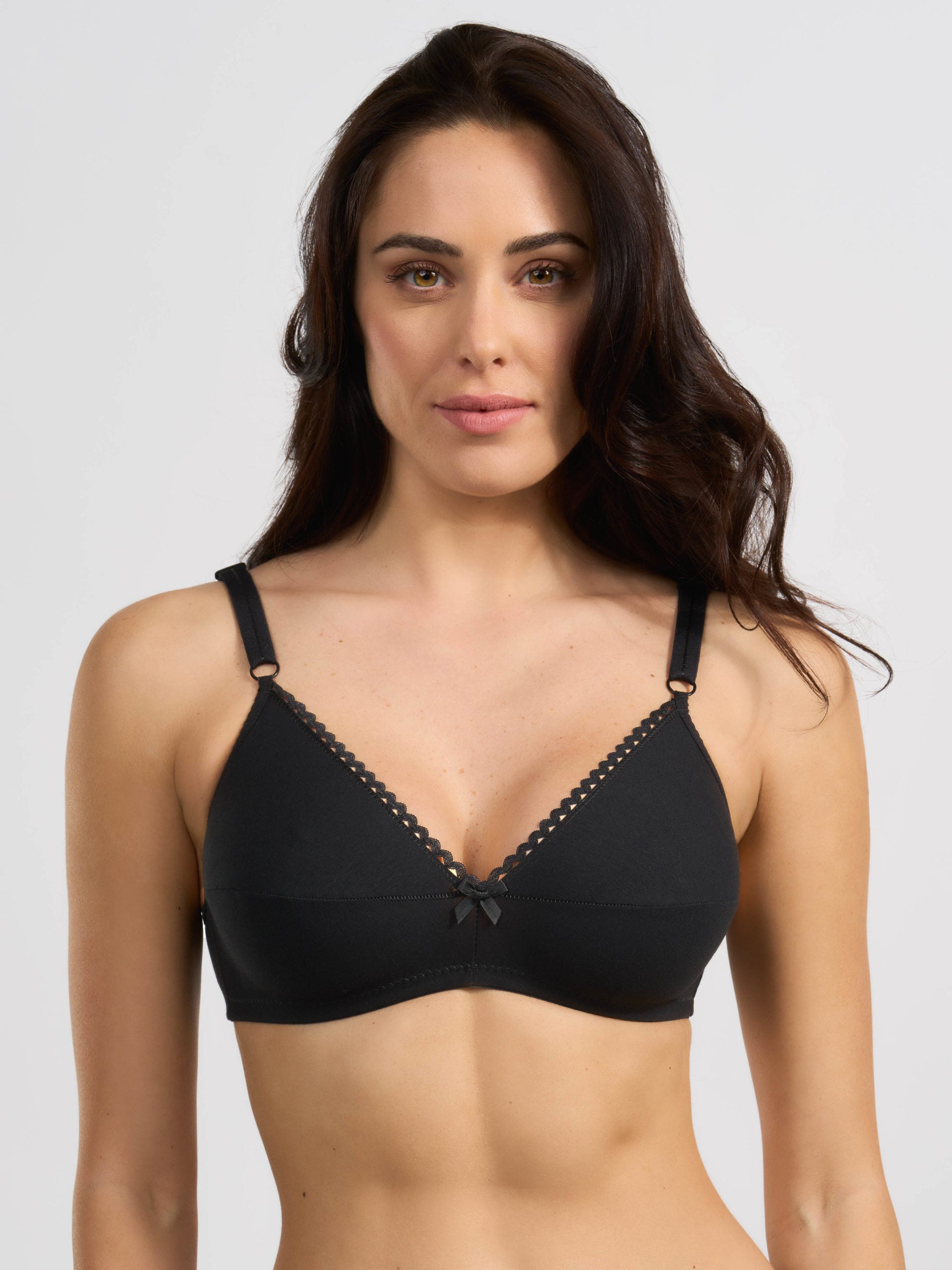 Reggiseno in cotone elasticizzato nero con bordo traforato e fiocco centrale.